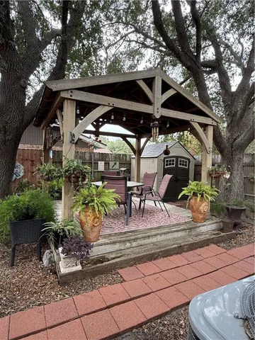 a view of a backyard with wooden fence