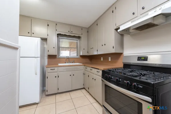 a kitchen with cabinets and appliances