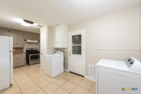a kitchen with a sink cabinets and stainless steel appliances