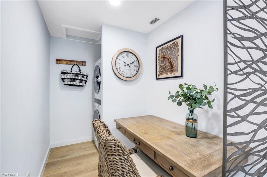 651 Bridge Way Lane, Unit 143 Naples, FL 34108 - Photo 11 of 27 a table with a vase and flowers on it