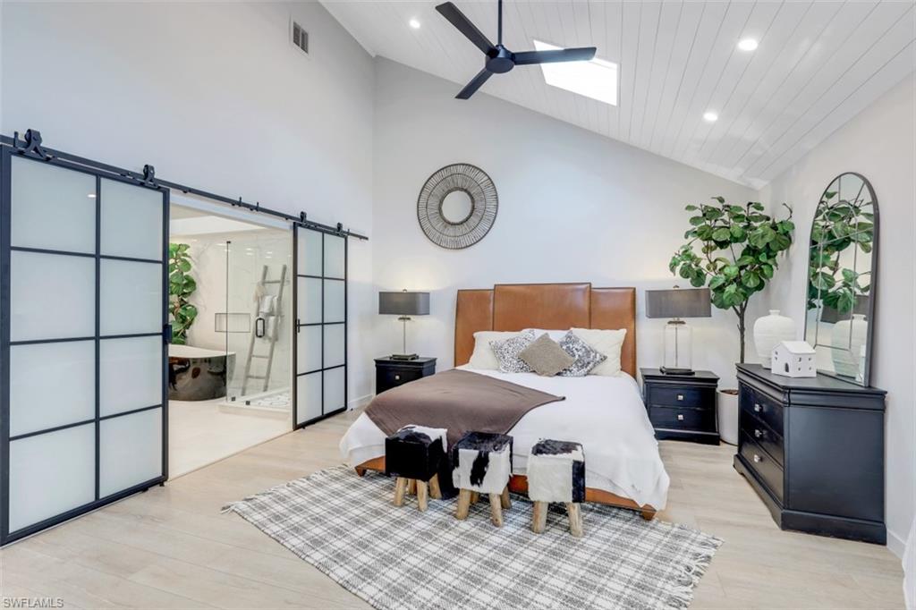 651 Bridge Way Lane, Unit 143 Naples, FL 34108 - Photo 12 of 27 a bedroom with a bed and a table