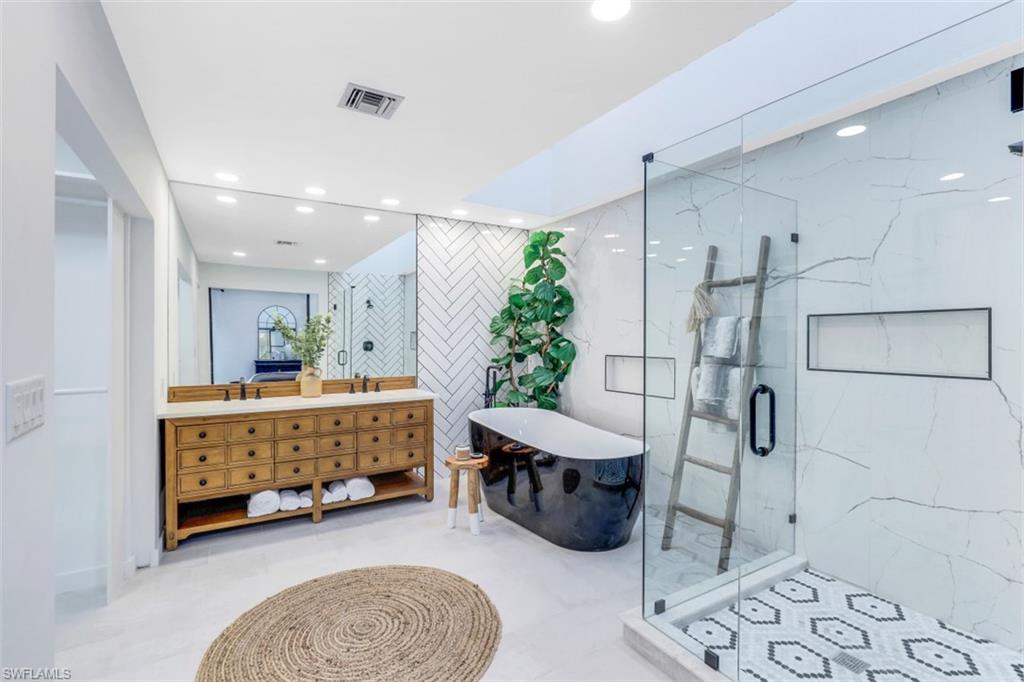 651 Bridge Way Lane, Unit 143 Naples, FL 34108 - Photo 14 of 27 a bathroom with a tub sink and shower