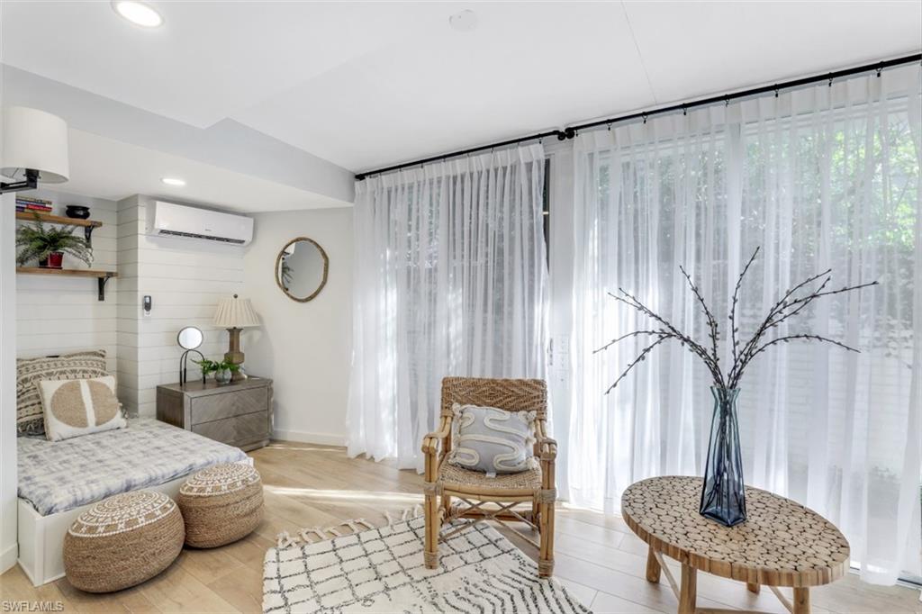 651 Bridge Way Lane, Unit 143 Naples, FL 34108 - Photo 18 of 27 a bedroom with a bed and a chair