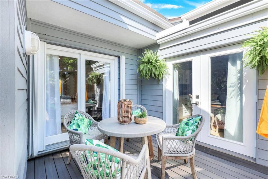 651 Bridge Way Lane, Unit 143 Naples, FL 34108 - Photo 19 of 27 a view of a house with patio and wooden floor