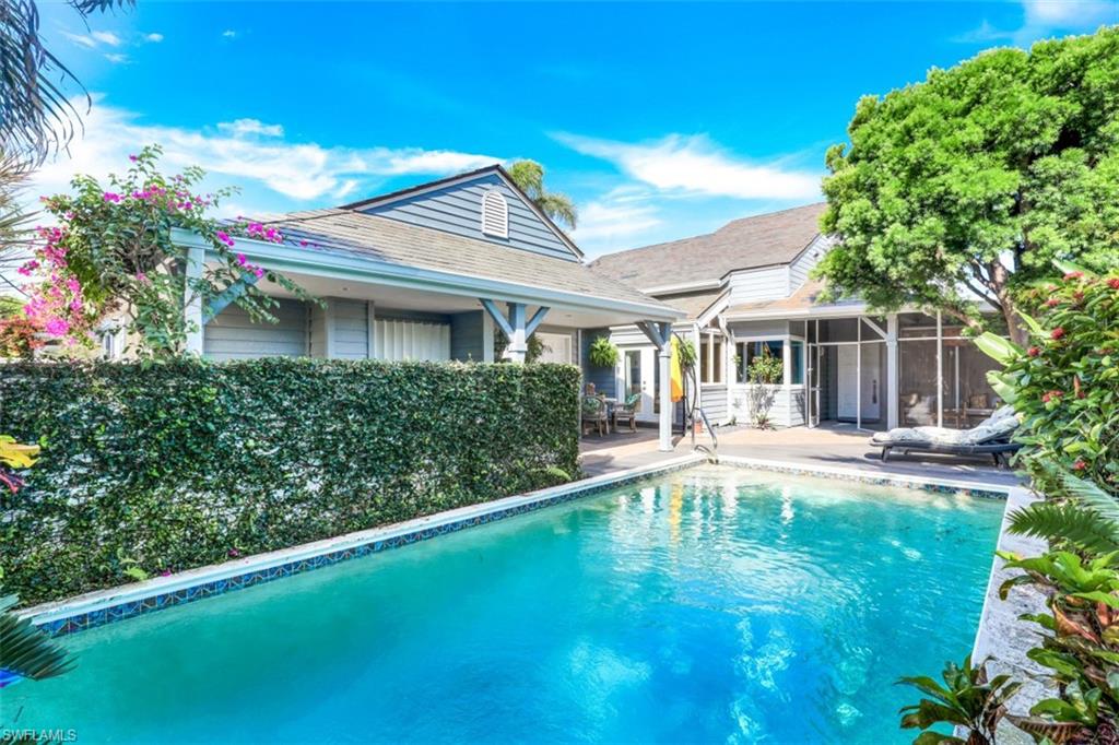651 Bridge Way Lane, Unit 143 Naples, FL 34108 - Photo 22 of 27 a view of house with swimming pool outdoor seating