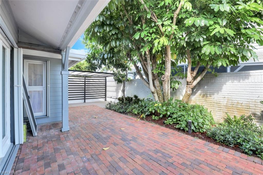 651 Bridge Way Lane, Unit 143 Naples, FL 34108 - Photo 25 of 27 a front view of a house with a yard