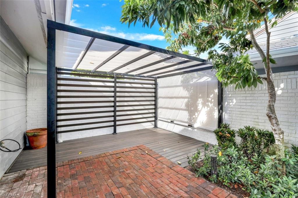 651 Bridge Way Lane, Unit 143 Naples, FL 34108 - Photo 26 of 27 a backyard of a house with seating space