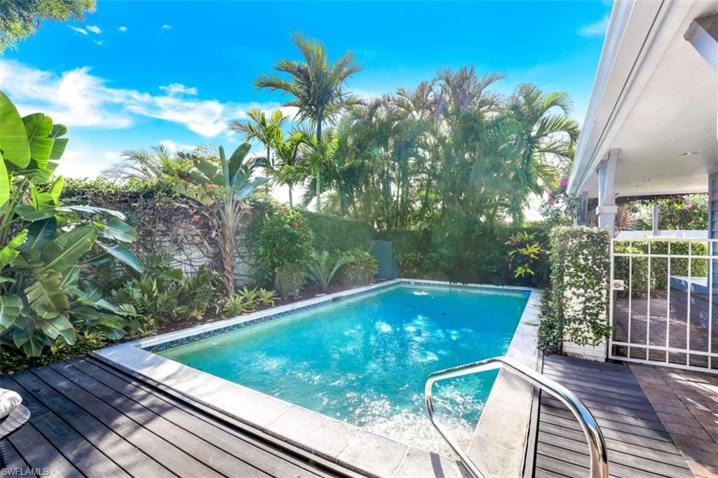 651 Bridge Way Lane, Unit 143 Naples, FL 34108 - Photo 3 of 27 a view of a swimming pool with a patio and plants