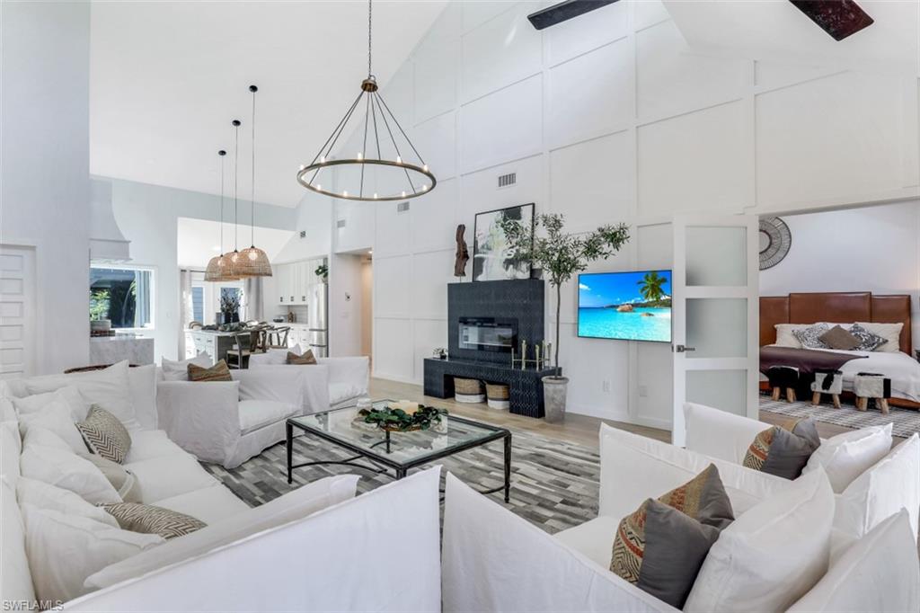 651 Bridge Way Lane, Unit 143 Naples, FL 34108 - Photo 4 of 27 a living room with furniture a flat screen tv and a window