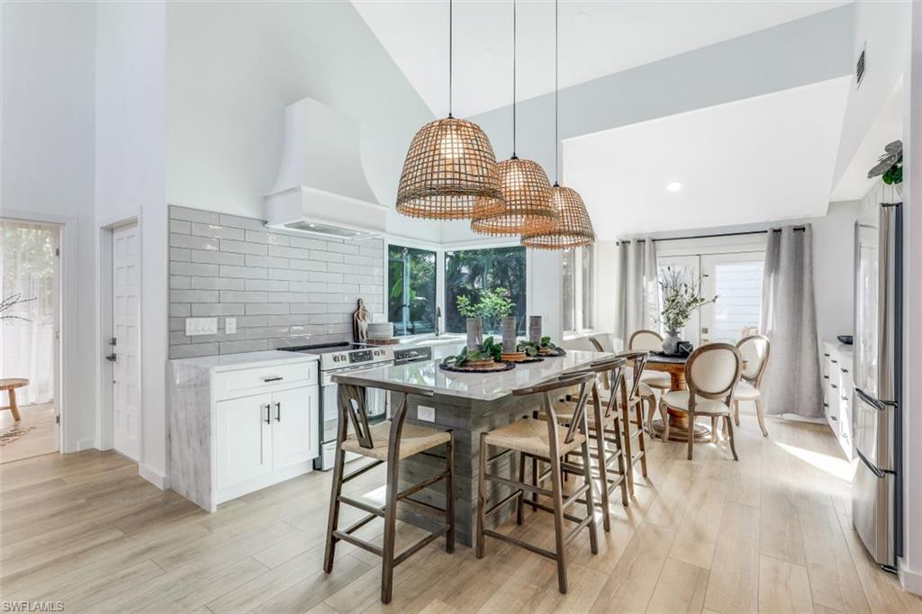 651 Bridge Way Lane, Unit 143 Naples, FL 34108 - Photo 6 of 27 a view of a dining room with furniture window and wooden floor