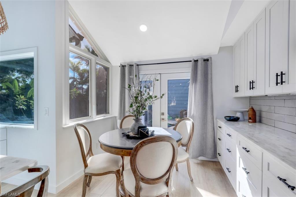 651 Bridge Way Lane, Unit 143 Naples, FL 34108 - Photo 9 of 27 a dining room with furniture and window