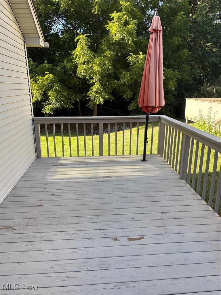 6695 Clingan Road, Unit 24 Youngstown, OH 44514 - Photo 24 of 26 Wooden deck with a lawn