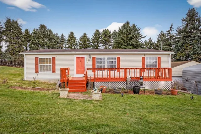 a front view of a house with a garden