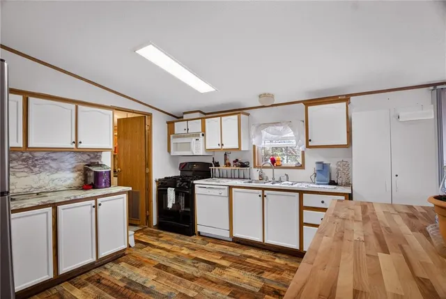 a kitchen with a sink stove and cabinets