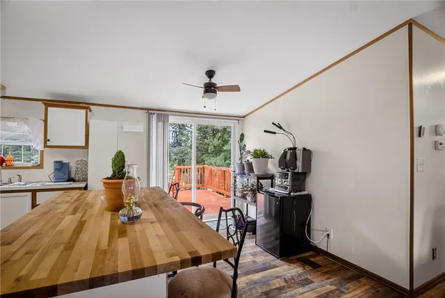 a view of a dining room with furniture large windows and wooden floor