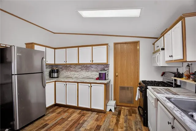 a kitchen with stainless steel appliances granite countertop a refrigerator and a stove