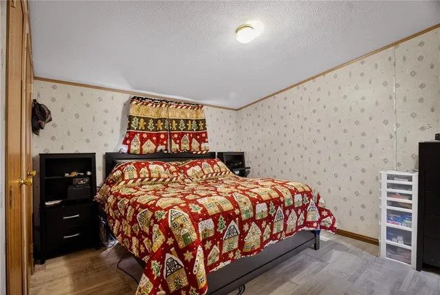 a bed sitting in a bedroom next to a cabinet