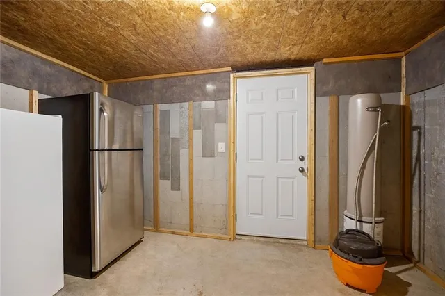 a room with stainless steel appliances a refrigerator and cabinets