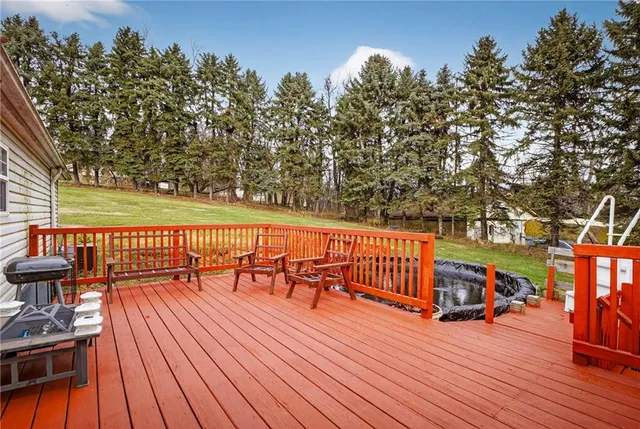 a balcony with wooden floor and outdoor seating