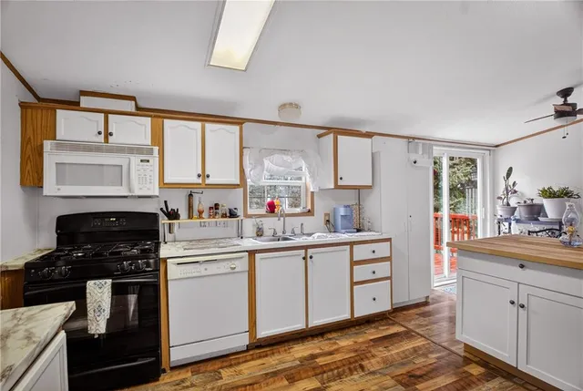 a kitchen with stainless steel appliances a stove sink and cabinets