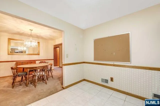 a kitchen with a stove and white cabinets