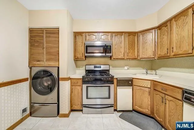 a kitchen with stove top oven and cabinets