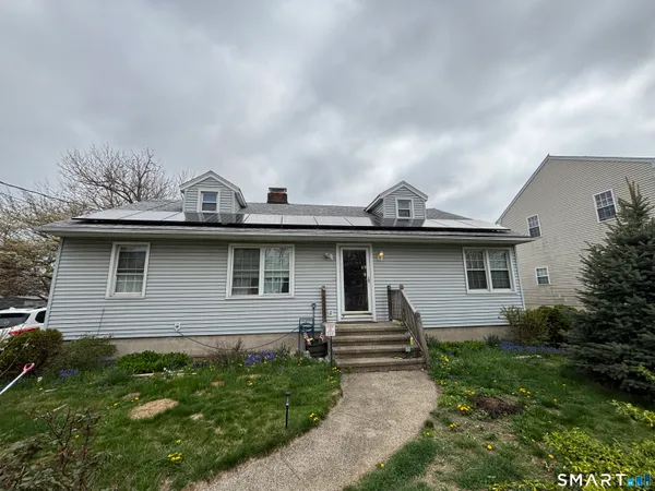 a view of a house with a yard and plants