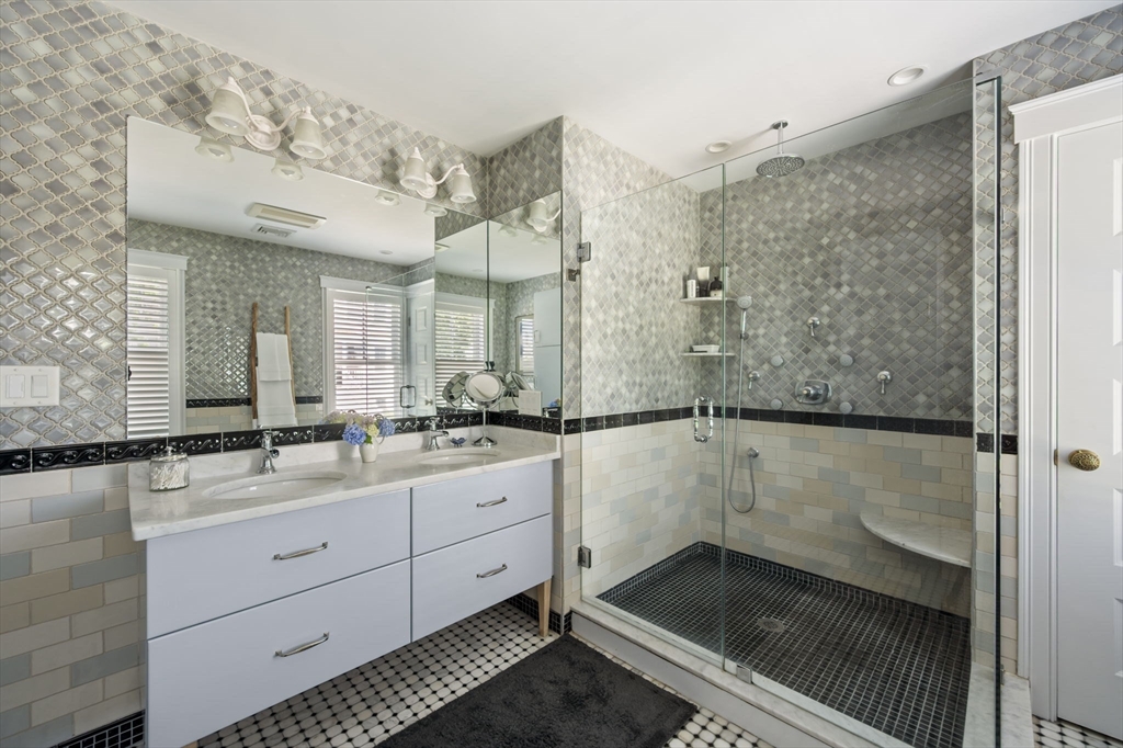 67 Hampton Circle Hull, MA 02045 - Photo 8 of 30 a bathroom with a shower sink and mirror