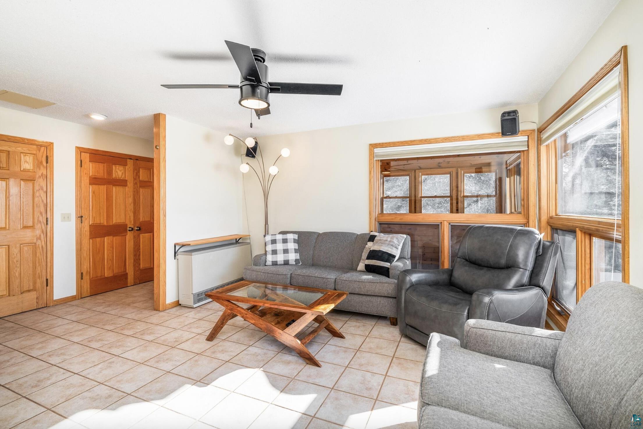 1480 Devil Track Road Grand Marais, MN 55604 - Photo 16 of 38 Living area with a ceiling fan and light tile patterned floors