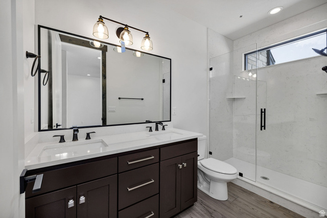 300 Knoll Loop, Unit 227 Fish Haven, ID 83287 - Photo 16 of 56 Bathroom with double vanity, a marble finish shower, recessed lighting, and light wood-style flooring