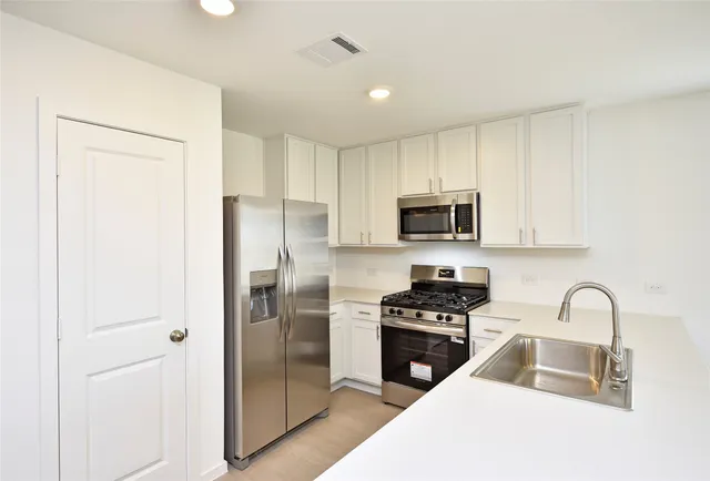 a kitchen with a refrigerator stove and microwave