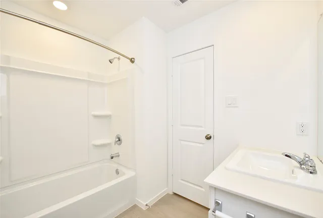 a bathroom with a bathtub and a sink