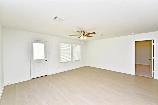 a view of an empty room with a window