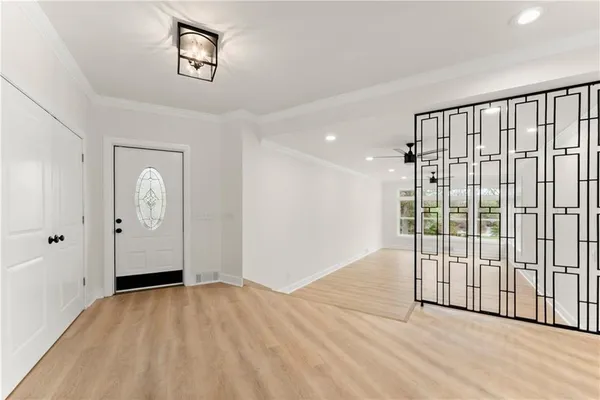 a view of a room with wooden floor and windows