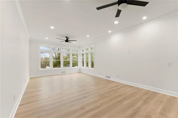 a view of a room with window wooden floor and windows