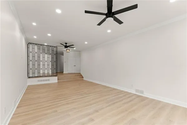 a large kitchen with a large counter top a sink stainless steel appliances and cabinets