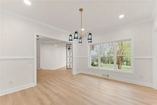 a large kitchen with kitchen island a large island in it