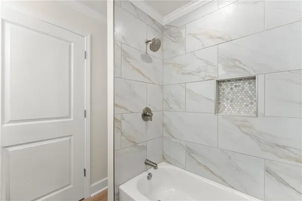 a bathroom with a granite countertop sink a toilet and shower