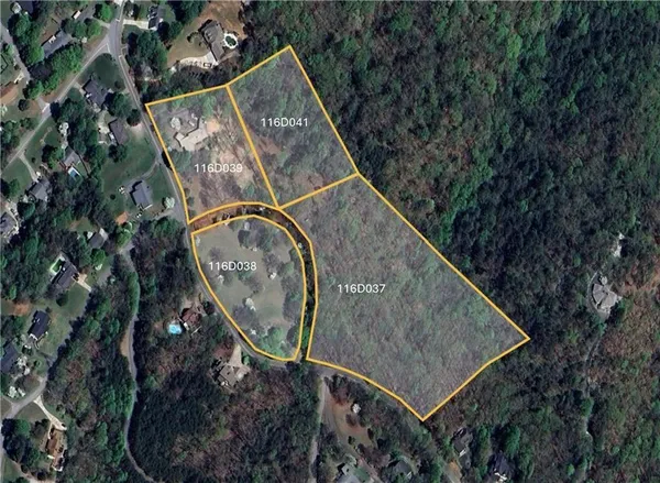 an aerial view of a house with a yard and street