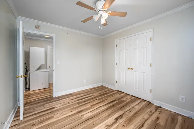 a view of a livingroom with wooden floor and a ceiling fan