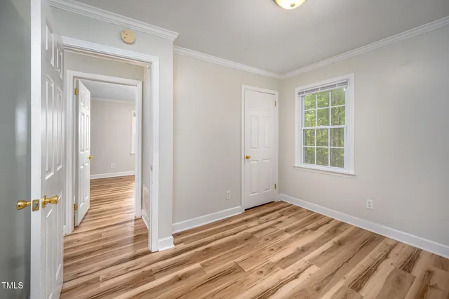 a view of a room with wooden floor and window