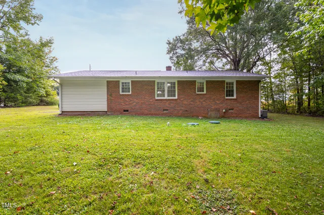 a view of a house with yard and a garden