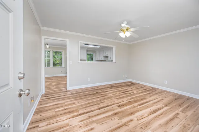 a view of empty room with wooden floor