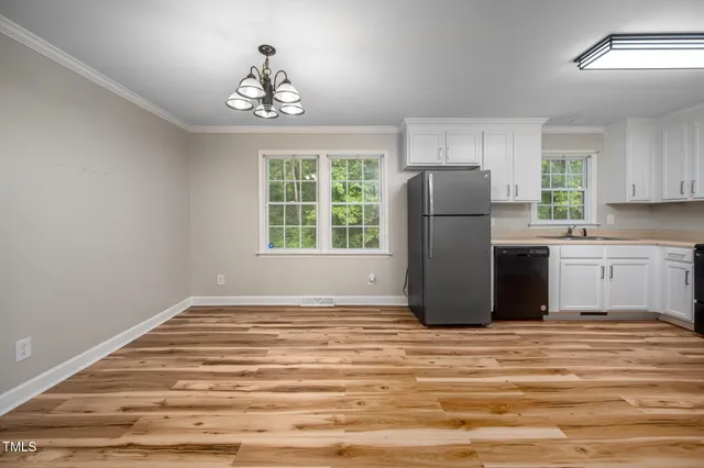 a view of a kitchen with a closet and windows