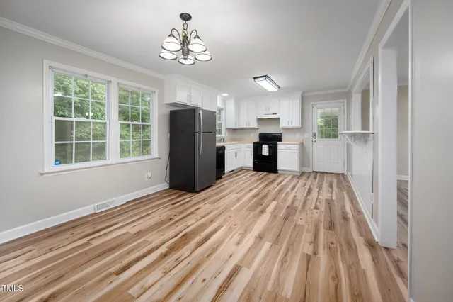 a view of a kitchen with a stove cabinets and a wooden floor