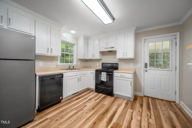 a kitchen with a refrigerator stove and sink