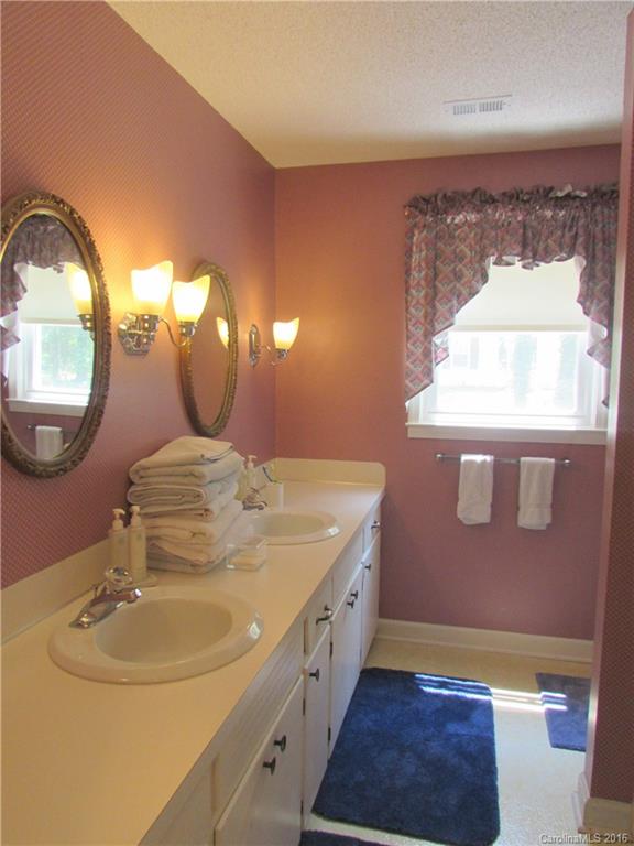 1515 Mallard Bay Road York, SC 29745 - Photo 17 of 24 a bathroom with a double vanity sink and a mirror