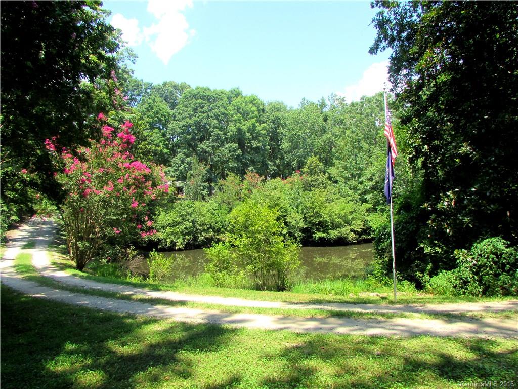1515 Mallard Bay Road York, SC 29745 - Photo 23 of 24 a view of a fountain in a yard with plants and large trees