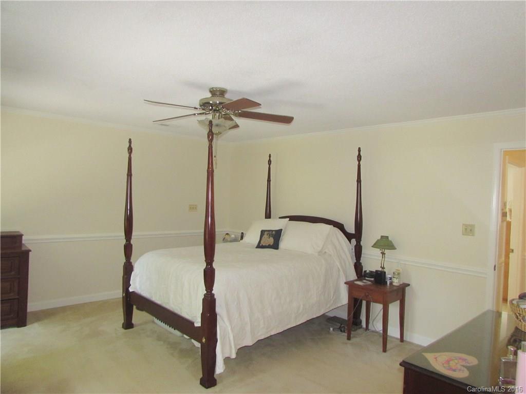 1515 Mallard Bay Road York, SC 29745 - Photo 10 of 24 a bedroom with a bed and a chandelier