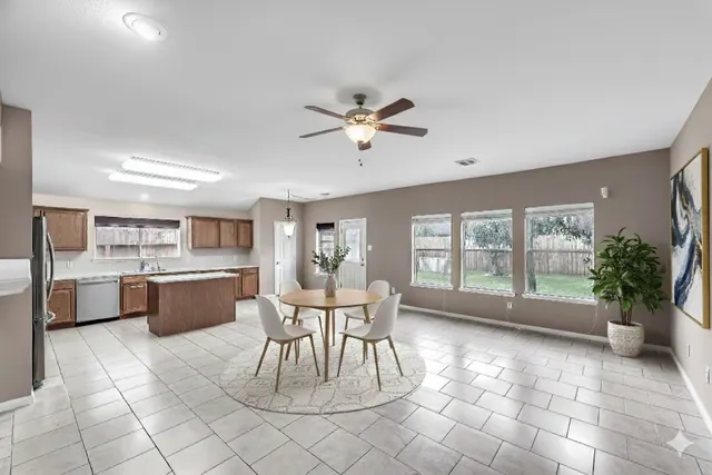 a dining area with a large window and table